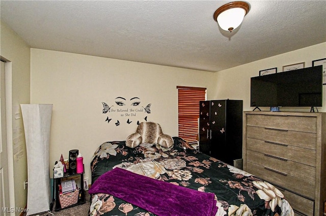 carpeted bedroom with a textured ceiling