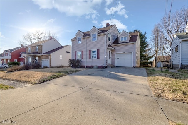 traditional-style home with concrete driveway and a garage