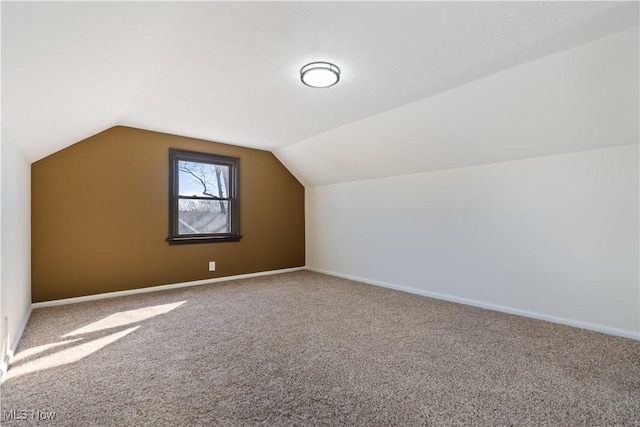 bonus room featuring carpet flooring, baseboards, and lofted ceiling