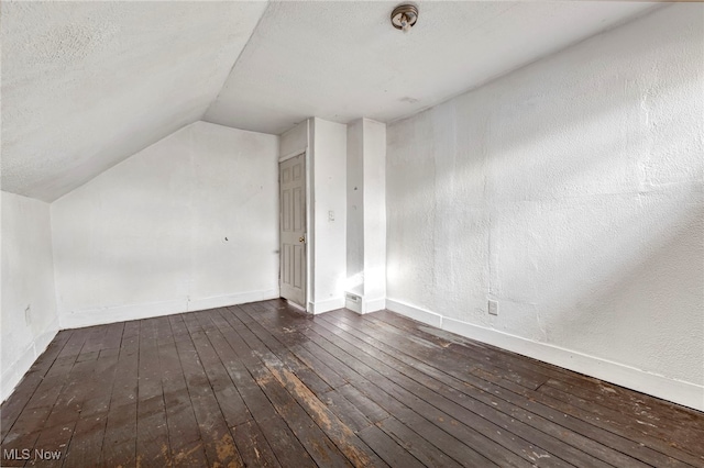 bonus room with vaulted ceiling, a textured ceiling, baseboards, and wood-type flooring