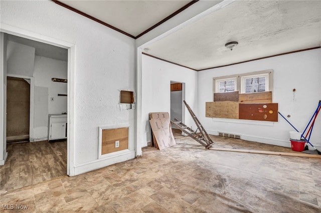 interior space with stone finish floor, baseboards, visible vents, and ornamental molding