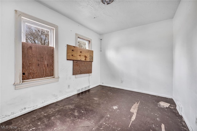 empty room with visible vents and baseboards