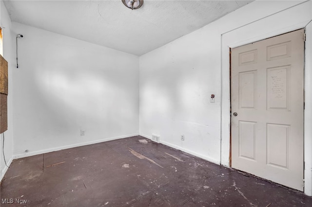 unfurnished room with visible vents and baseboards