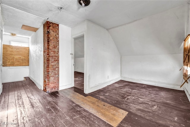 bonus room with lofted ceiling and hardwood / wood-style floors