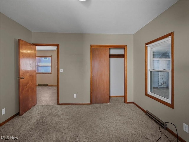 unfurnished bedroom featuring a closet, baseboards, and carpet floors