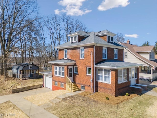 american foursquare style home with a garage, brick siding, concrete driveway, and a shingled roof