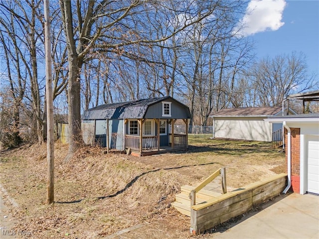 view of front of property with a garage, an outbuilding, brick siding, and concrete driveway