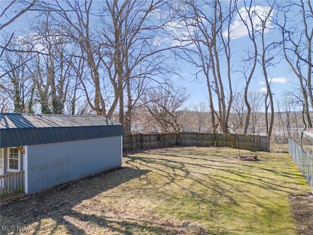 view of yard featuring an outdoor structure and a fenced backyard