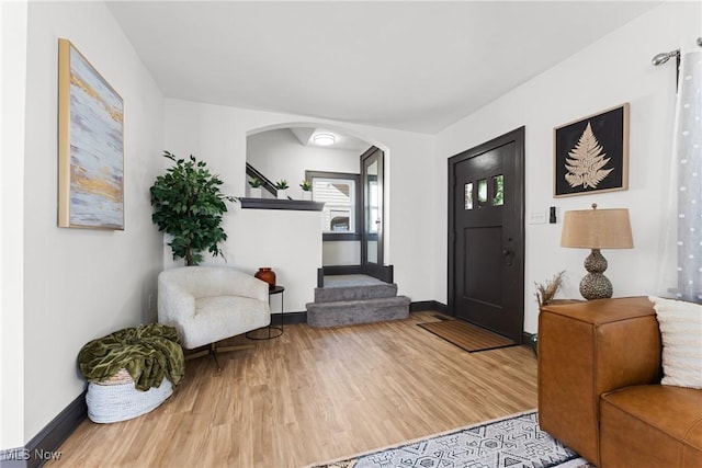 entrance foyer featuring baseboards and wood finished floors