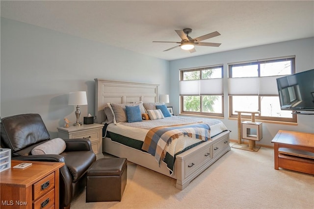 bedroom with multiple windows, light colored carpet, baseboards, and ceiling fan