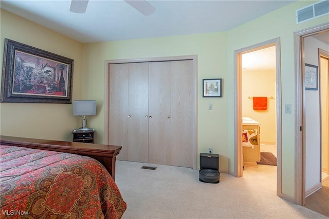 carpeted bedroom with a closet, visible vents, baseboards, and a ceiling fan