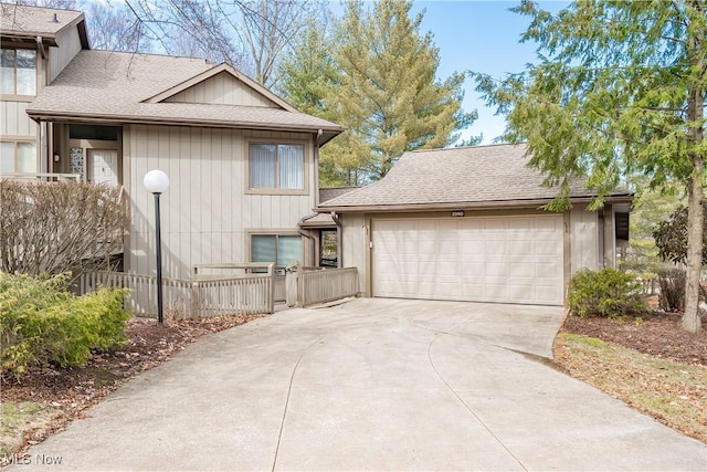 view of home's exterior featuring a garage and roof with shingles