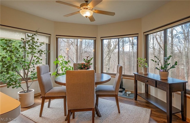 dining space featuring wood finished floors and ceiling fan