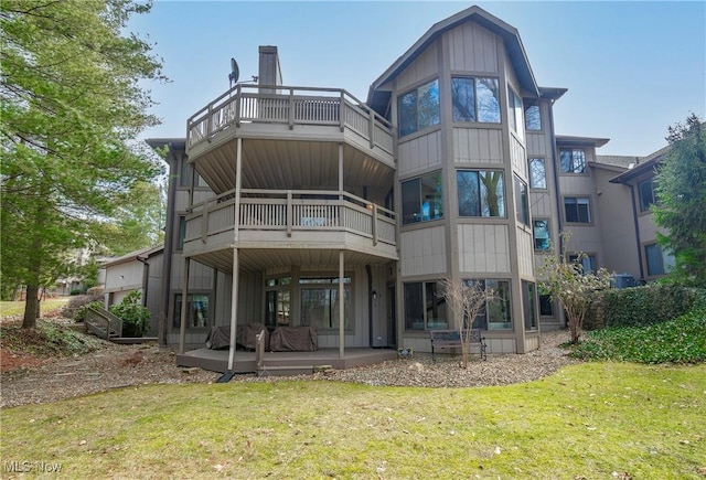 rear view of property with a yard and board and batten siding