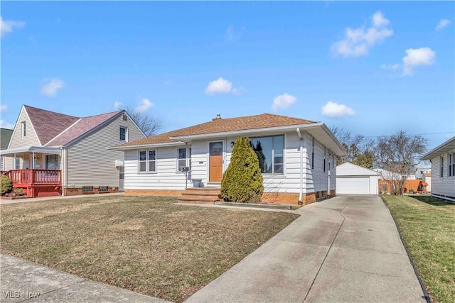 bungalow-style house featuring a front yard, a detached garage, and an outdoor structure