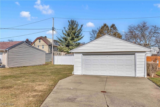 detached garage featuring fence