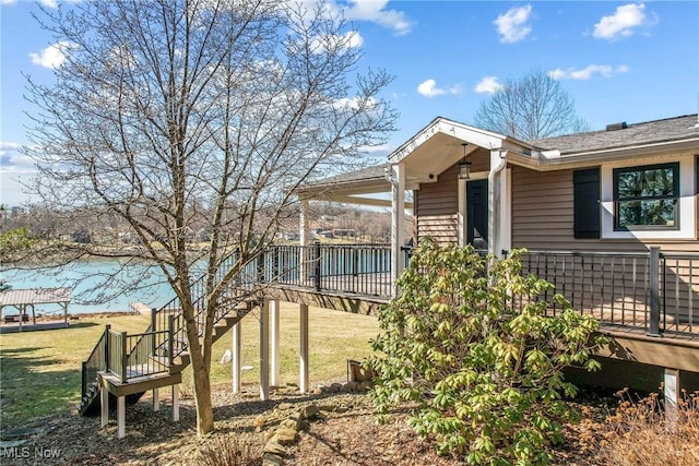 view of property exterior featuring a yard, a deck, and stairs