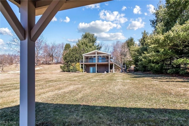 view of yard with stairs and a deck