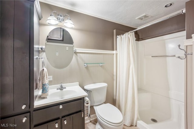 bathroom featuring visible vents, toilet, a stall shower, wainscoting, and vanity