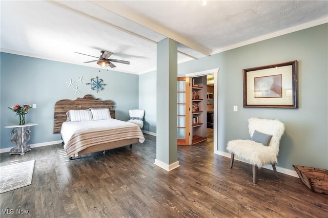 bedroom with wood finished floors, baseboards, beam ceiling, ceiling fan, and ornamental molding