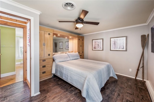 bedroom with visible vents, baseboards, dark wood-style floors, and ornamental molding