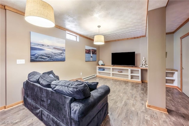 living room with crown molding, wood finished floors, baseboards, and a textured ceiling