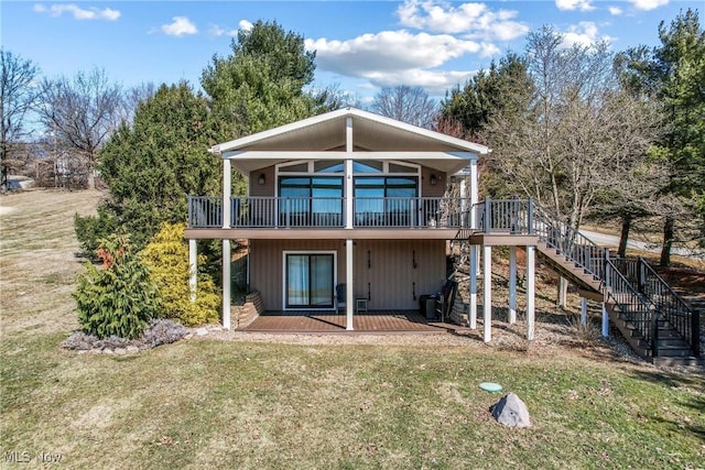 back of house featuring stairway, a yard, and a wooden deck