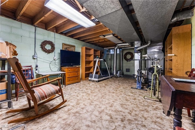 workout room featuring concrete block wall