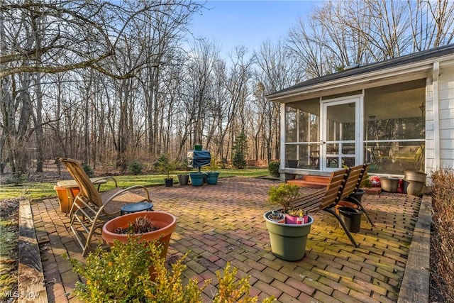 view of patio with a sunroom