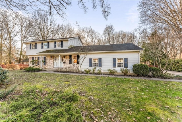 view of front of house with a front yard and a porch