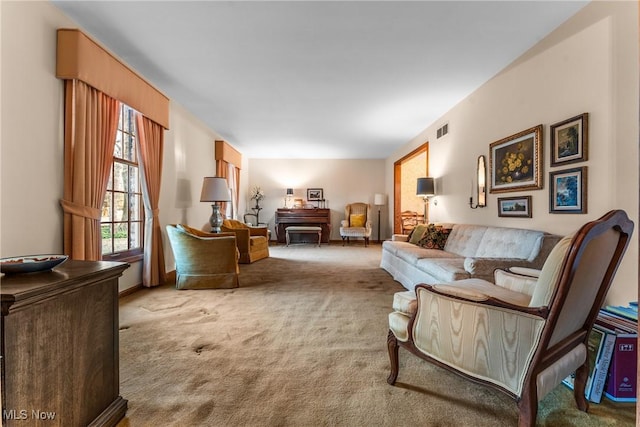 carpeted living area featuring visible vents