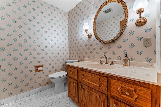 bathroom with visible vents, wallpapered walls, toilet, tile patterned floors, and vanity