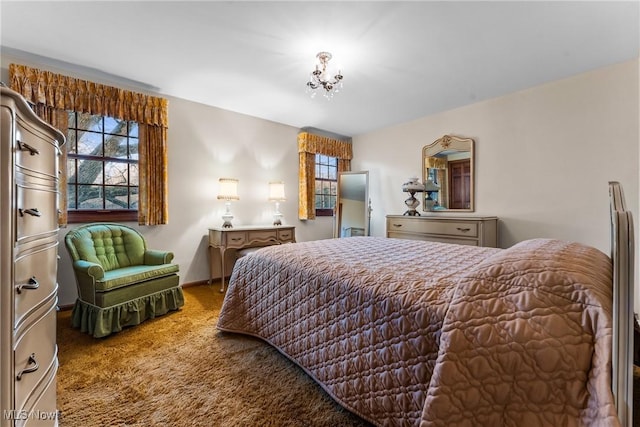 bedroom with an inviting chandelier, baseboards, and carpet floors