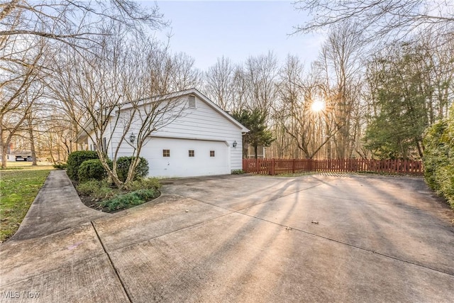 view of side of property with a garage and fence