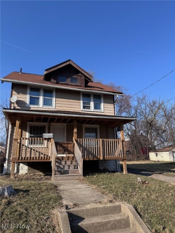 american foursquare style home with covered porch