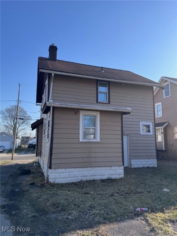 rear view of property with a chimney