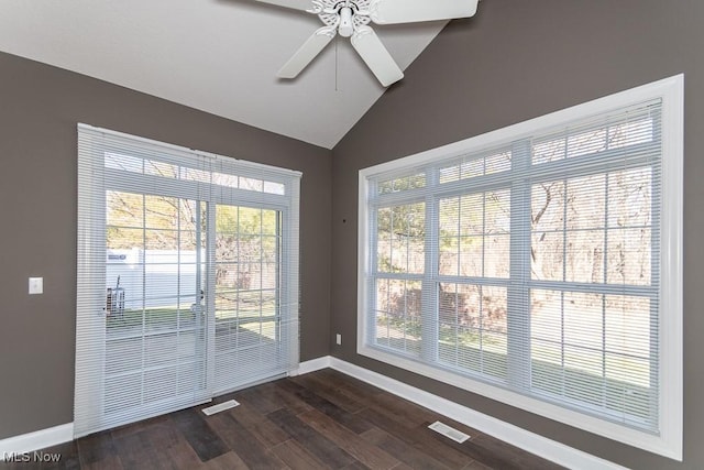 interior space with dark wood finished floors, visible vents, a healthy amount of sunlight, and lofted ceiling