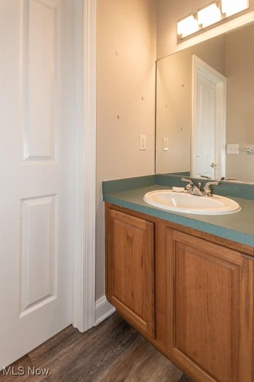 bathroom with wood finished floors and vanity