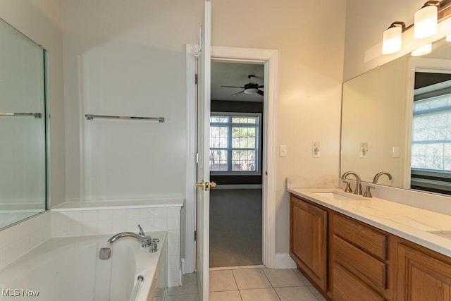 bathroom featuring a ceiling fan, double vanity, a sink, tile patterned flooring, and a bath