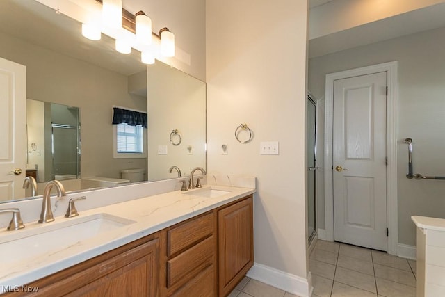 bathroom with tile patterned floors, a shower stall, toilet, and a sink