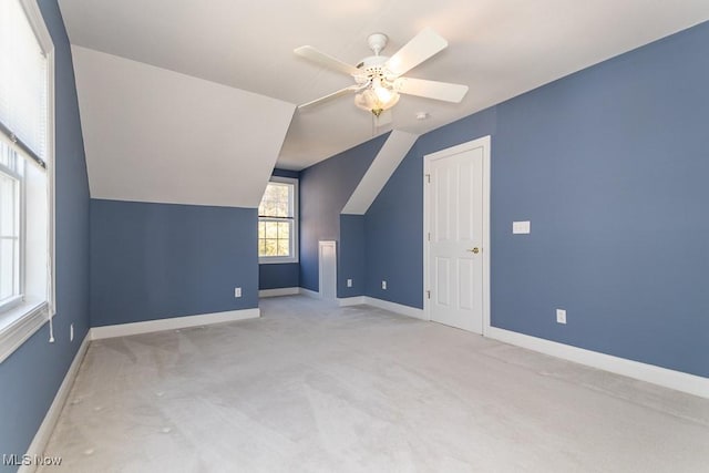 additional living space with lofted ceiling, a ceiling fan, baseboards, and carpet floors