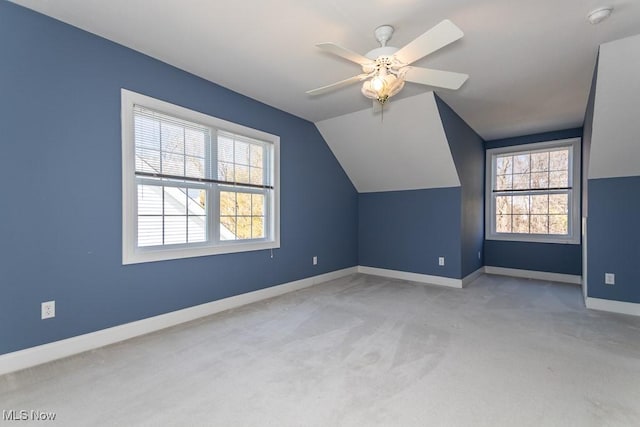 bonus room featuring vaulted ceiling, plenty of natural light, carpet, and baseboards