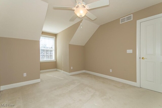 bonus room with baseboards, visible vents, ceiling fan, vaulted ceiling, and light carpet