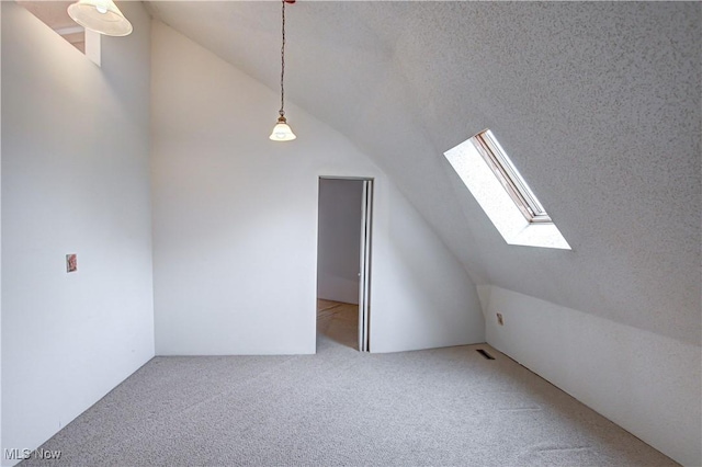 bonus room with visible vents, lofted ceiling with skylight, carpet, and a textured ceiling