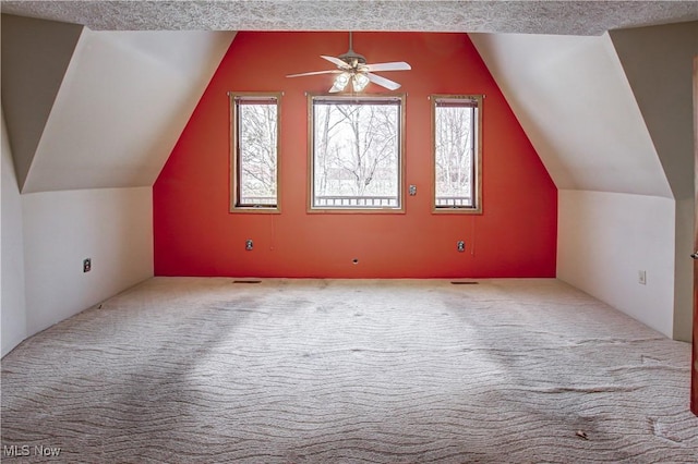 additional living space with plenty of natural light, carpet, and vaulted ceiling