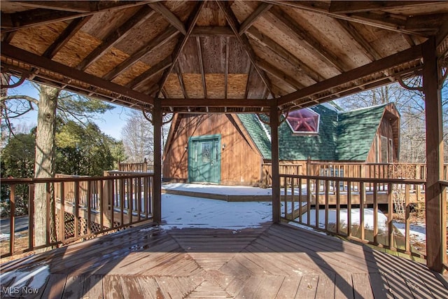 wooden deck with a gazebo, a storage unit, and an outdoor structure