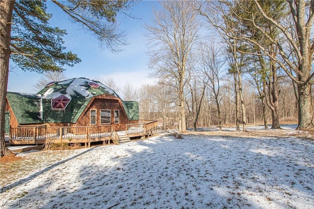 snowy yard with a wooden deck