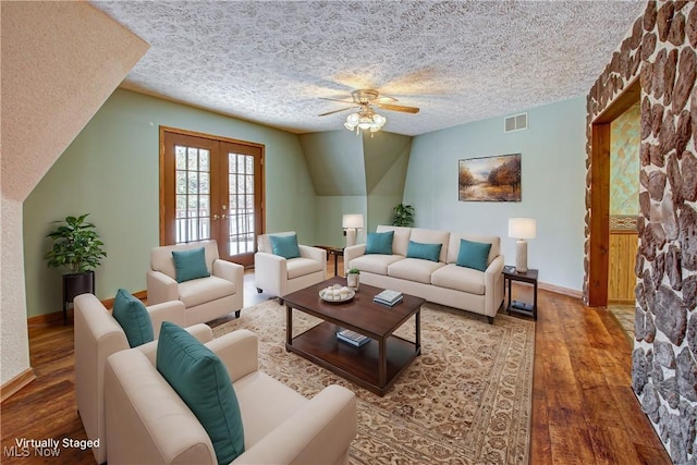 living room featuring wood finished floors, baseboards, visible vents, french doors, and a textured ceiling