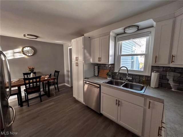 kitchen featuring a sink, white cabinetry, appliances with stainless steel finishes, light countertops, and decorative backsplash