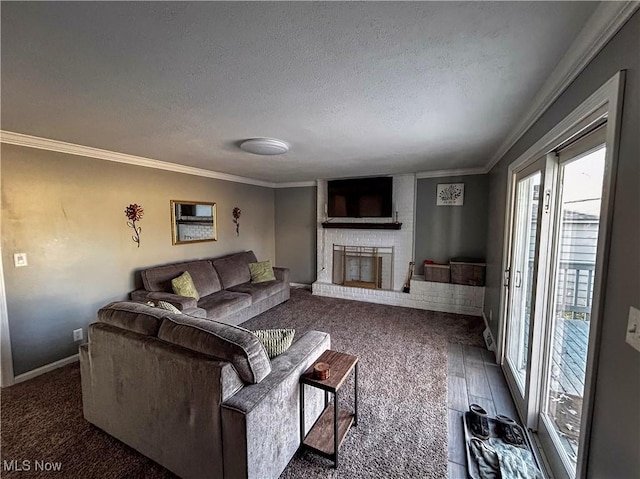 living room with a brick fireplace, a textured ceiling, baseboards, and ornamental molding